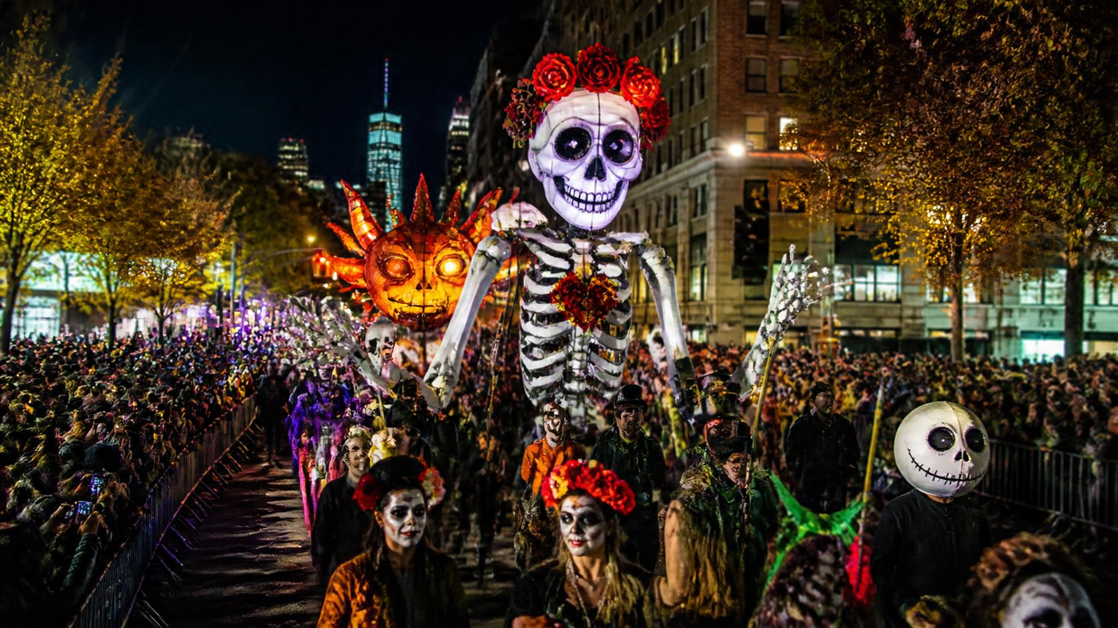 Giant skeleton puppet and costumed marchers at the nighttime Village Halloween Parade in New York City