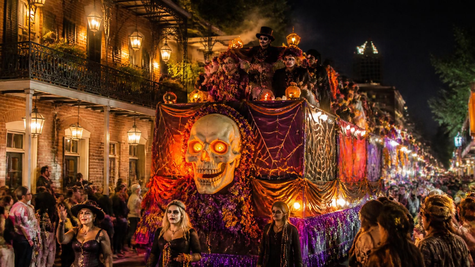 Illuminated Halloween parade floats and costumed paraders in the French Quarter at night during Krewe of Boo in New Orleans